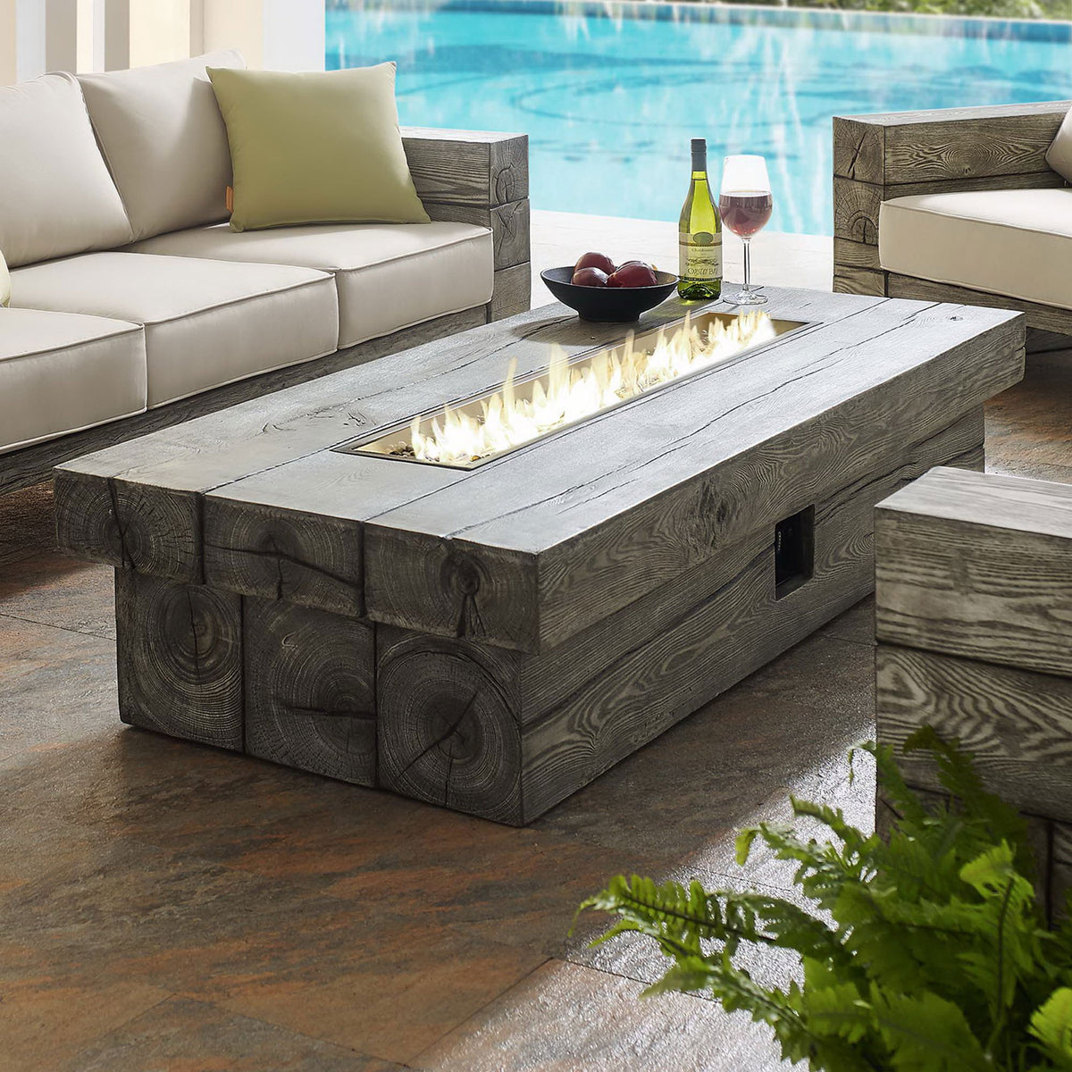 Spacious outdoor seating group gathered around the rectangular fire pit table by the pool || EEI-3563-LGR || front_angle_on_room