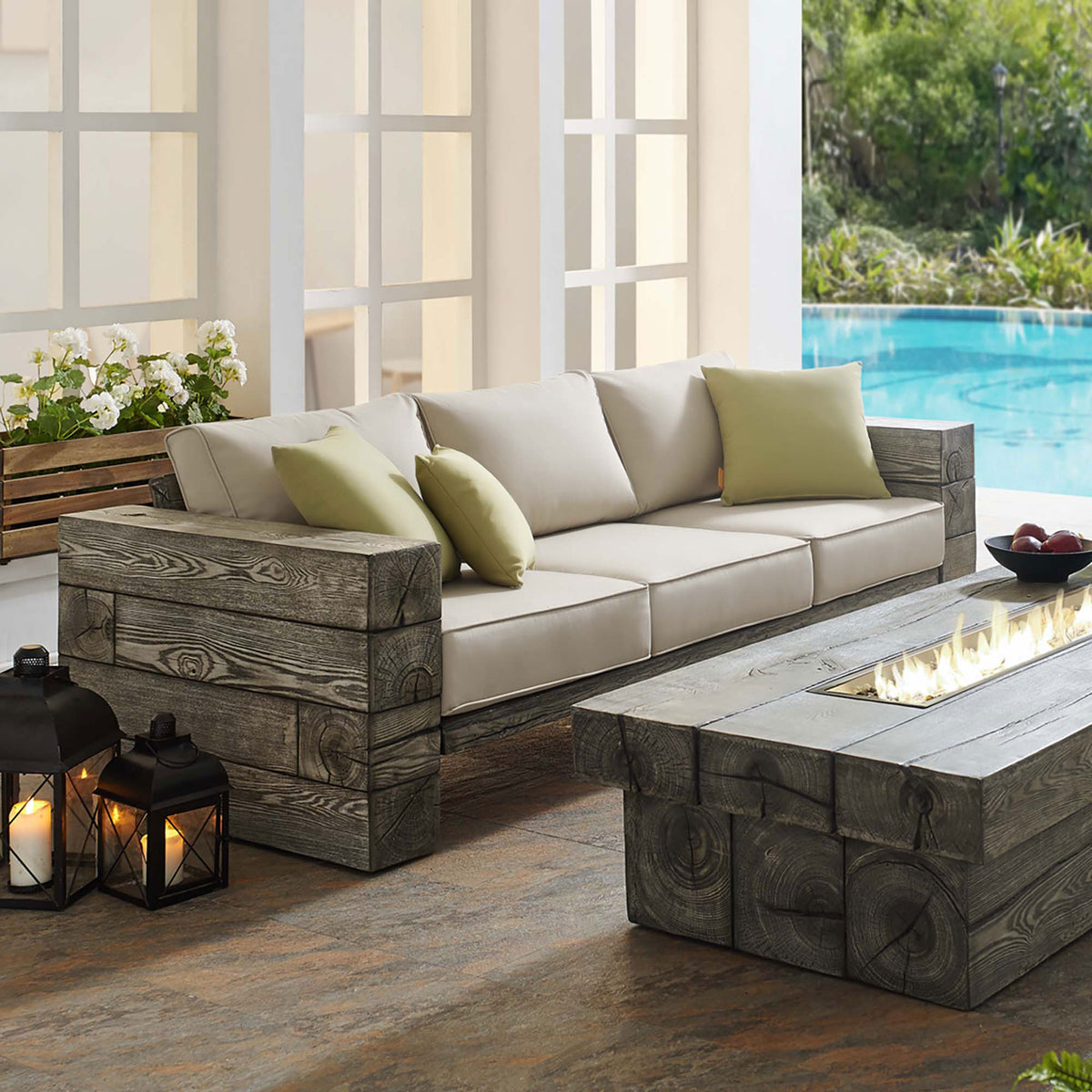 Manteo outdoor sofa with beige cushions on a driftwood-look block frame beside a modern fire pit table || EEI-3565-LGR-BEI || front_angle_room