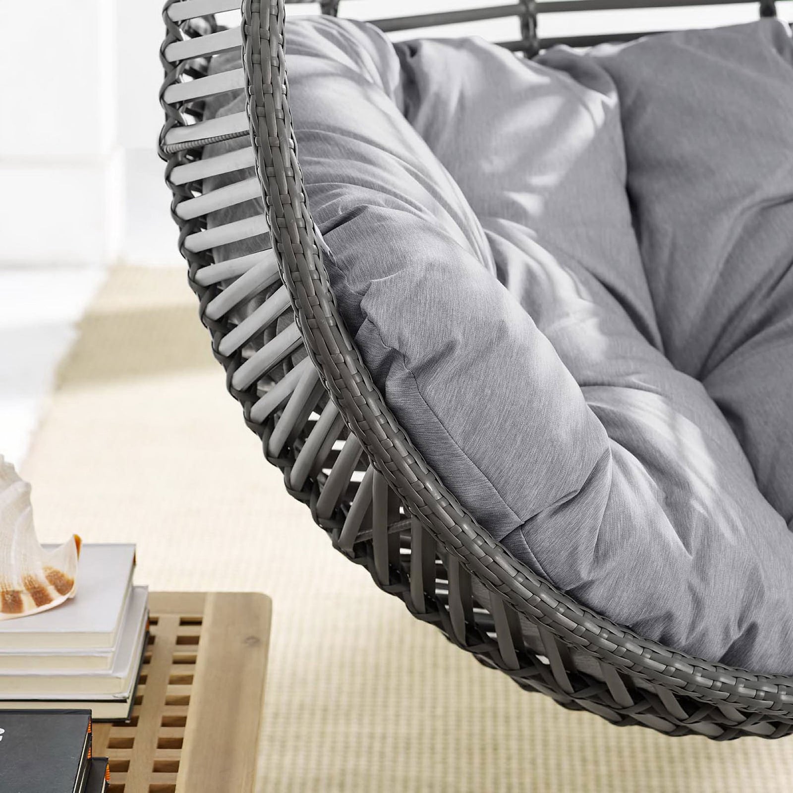 Gray tufted cushion nestled in a woven wicker frame, emphasizing plush comfort and detailed rattan texture. || EEI-3614-GRY-GRY || detail_room