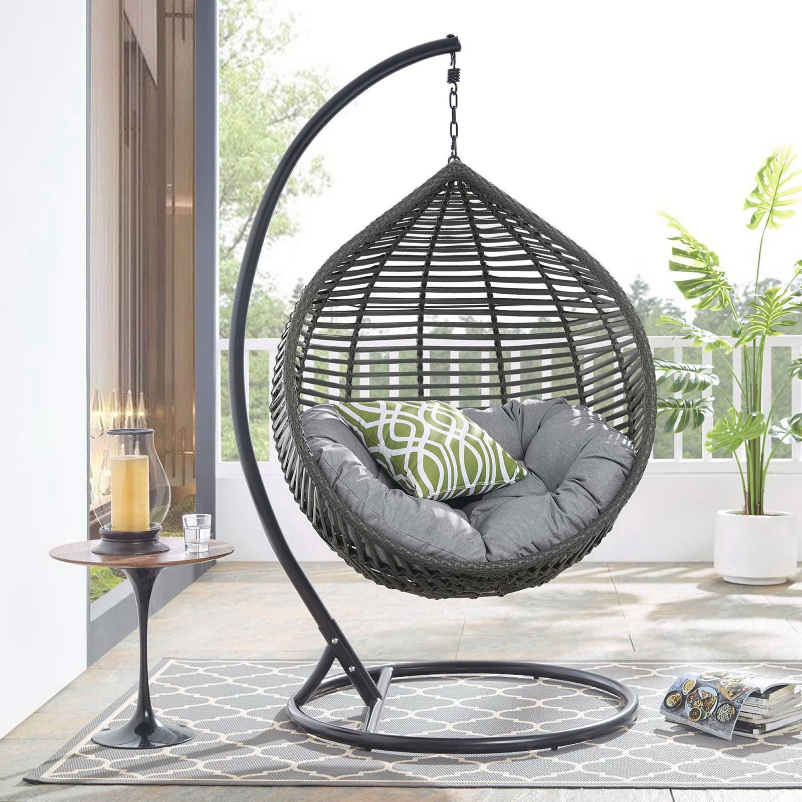 Teardrop swing chair with gray cushion and accent pillow bringing resort-style comfort to a modern patio. || EEI-3614-GRY-GRY || front_angle_room