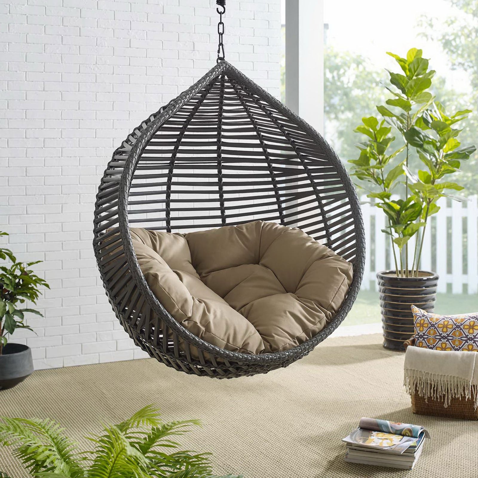 Hanging teardrop chair with mocha cushion bringing relaxed comfort to a sunlit outdoor retreat. || EEI-3614-GRY-MOC || front_angle_room