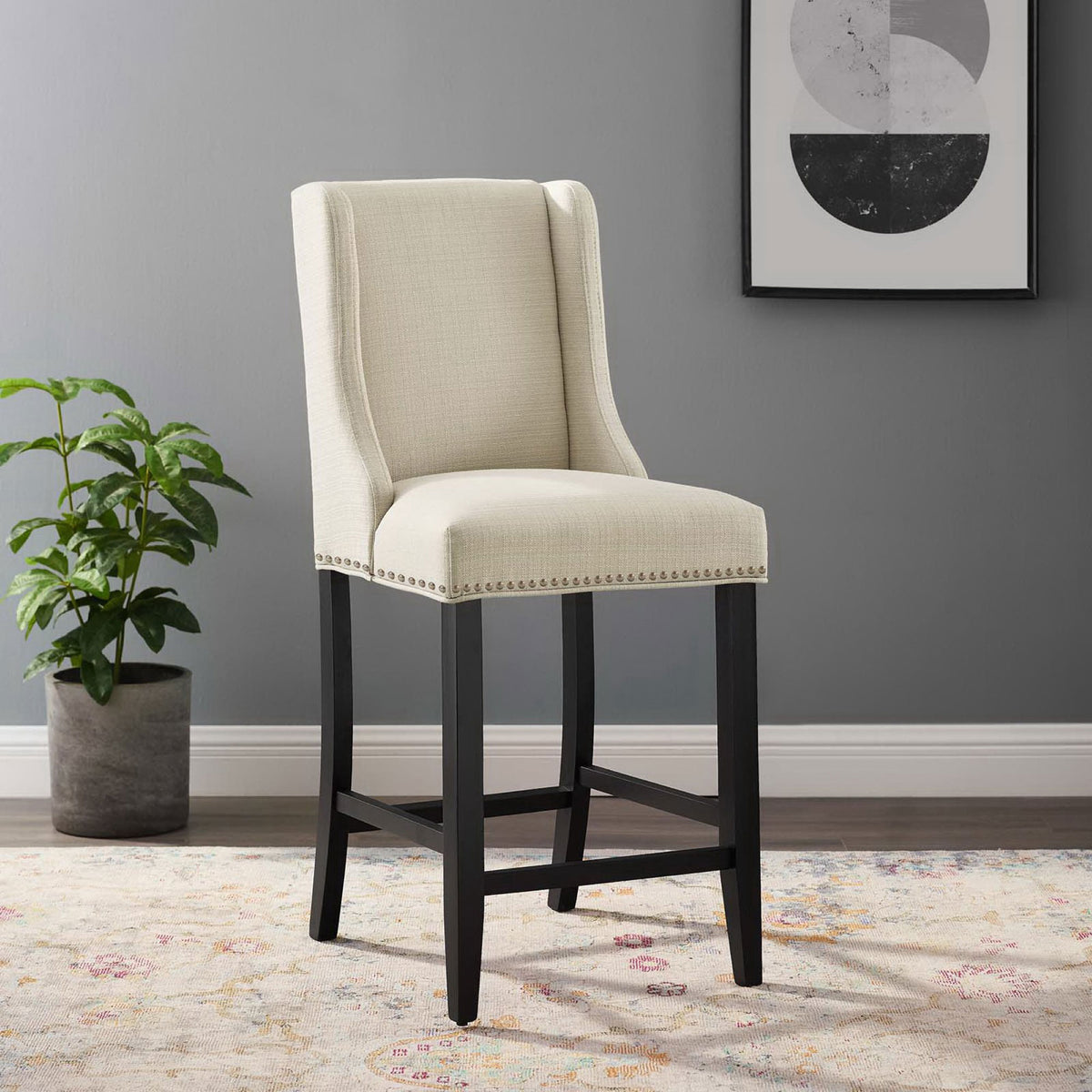 Beige counter stool elevates kitchens with timeless lines, nailhead accents, and a supportive footrest || EEI-3735-BEI || front_angle_room
