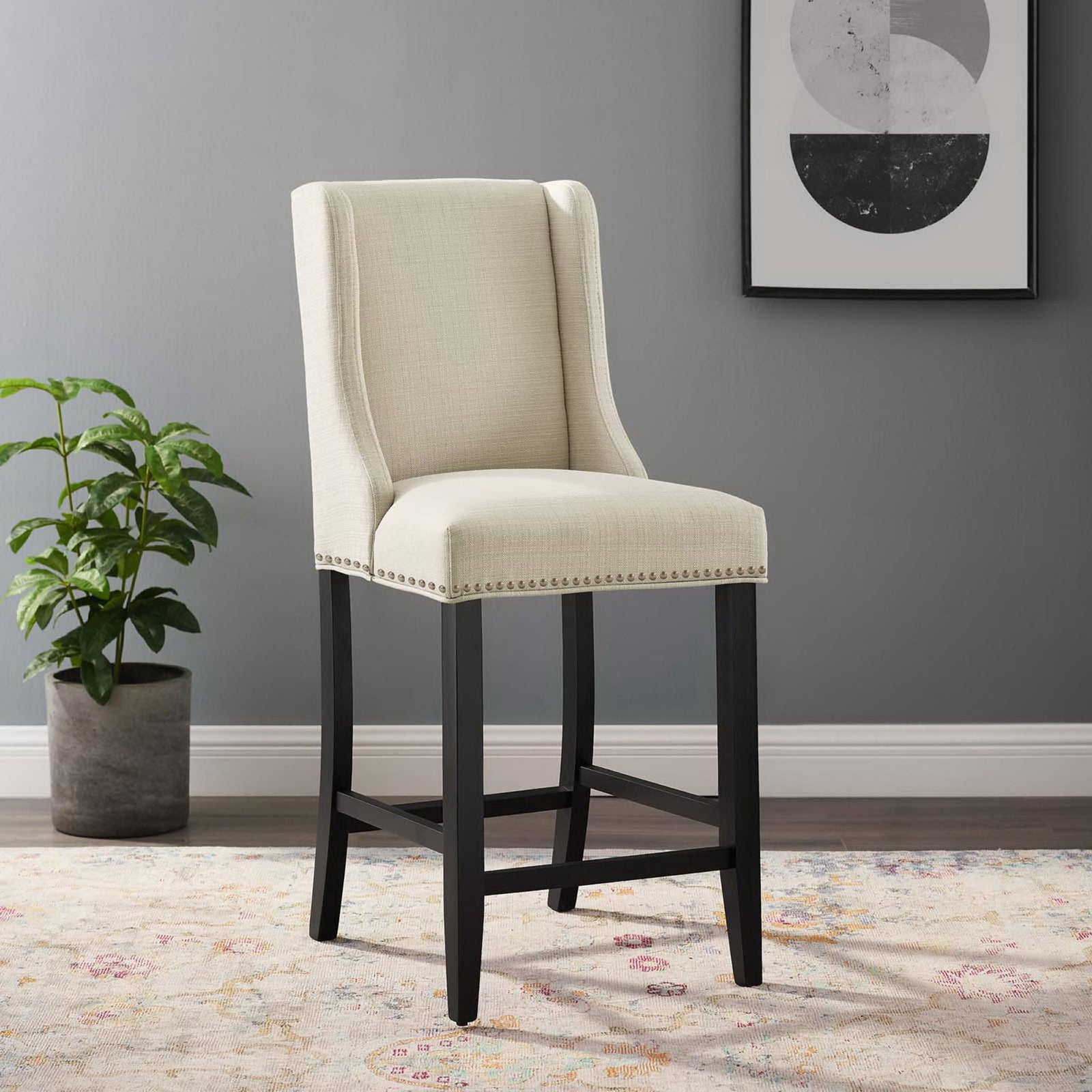 Beige counter stool elevates kitchens with timeless lines, nailhead accents, and a supportive footrest || EEI-3735-BEI || front_angle_room