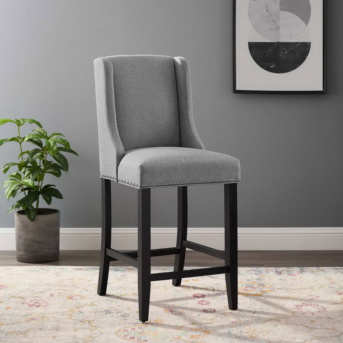 Elevates your counter with light gray upholstery, nailhead trim, and a solid black wood base. || EEI-3735-LGR || front_angle_room