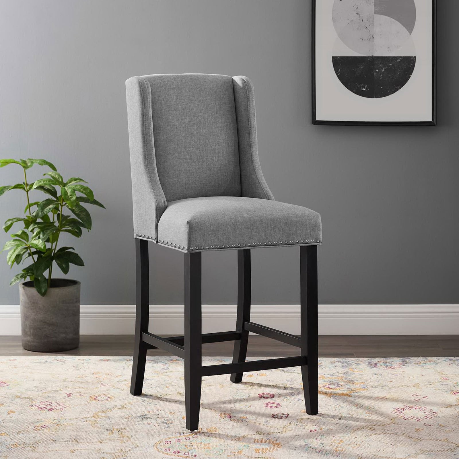 Elevates your counter with light gray upholstery, nailhead trim, and a solid black wood base. || EEI-3735-LGR || front_angle_room