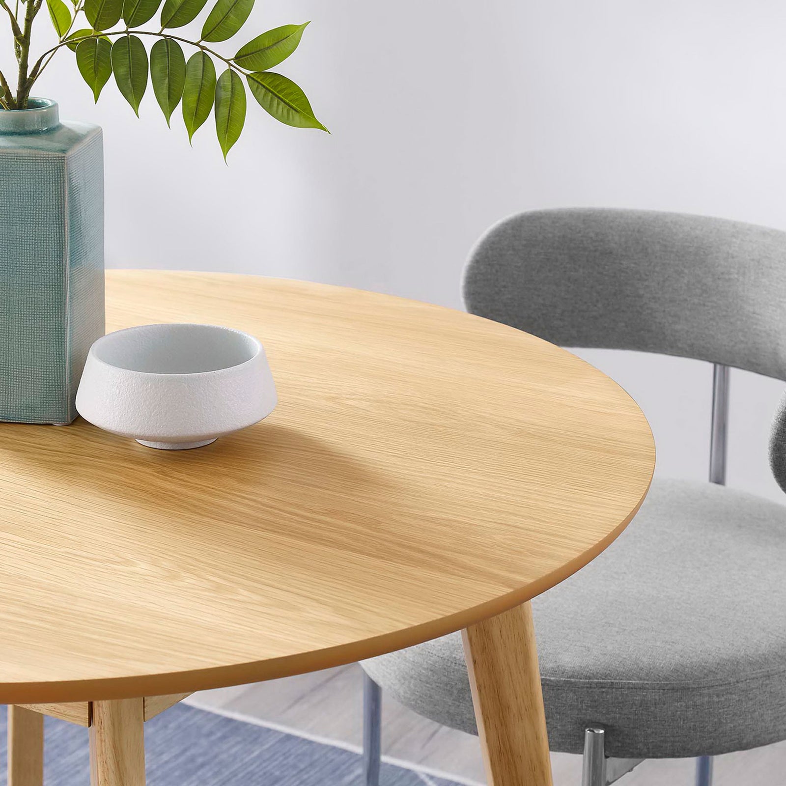 Round oak dining tabletop styled with modern decor to showcase smooth finish and inviting tone || EEI-3749-OAK || detail_room