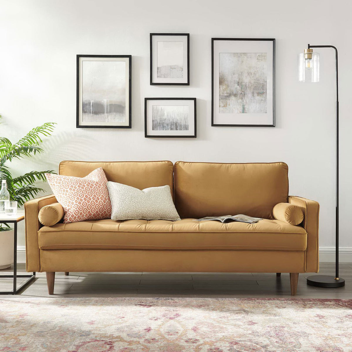 Cognac Valour velvet sofa anchored in a bright living room with rug, floor lamp, and wall art || EEI-3764-COG || front_room