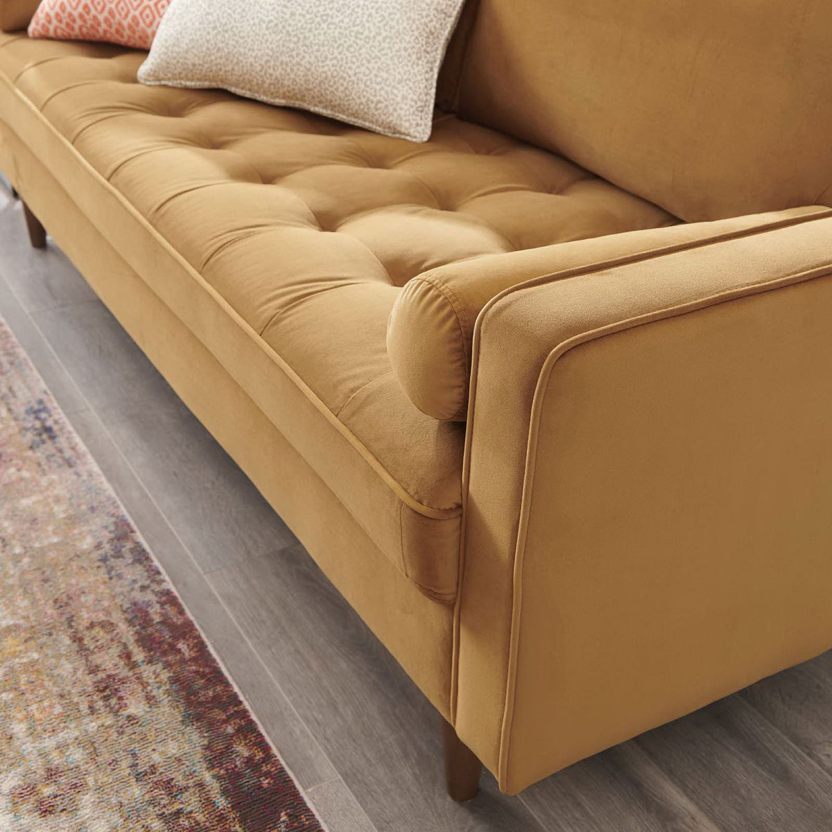 Cognac Valour velvet sofa styled in a living room with accent pillows and a tufted seat cushion || EEI-3764-COG || detail_room
