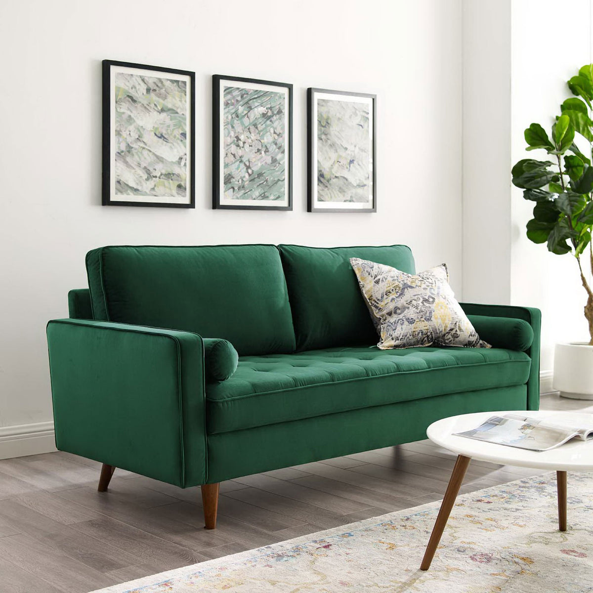 Green Valour velvet sofa styled in a modern living room with art, rug, and accent pillow || EEI-3764-GRN || front_angle_room