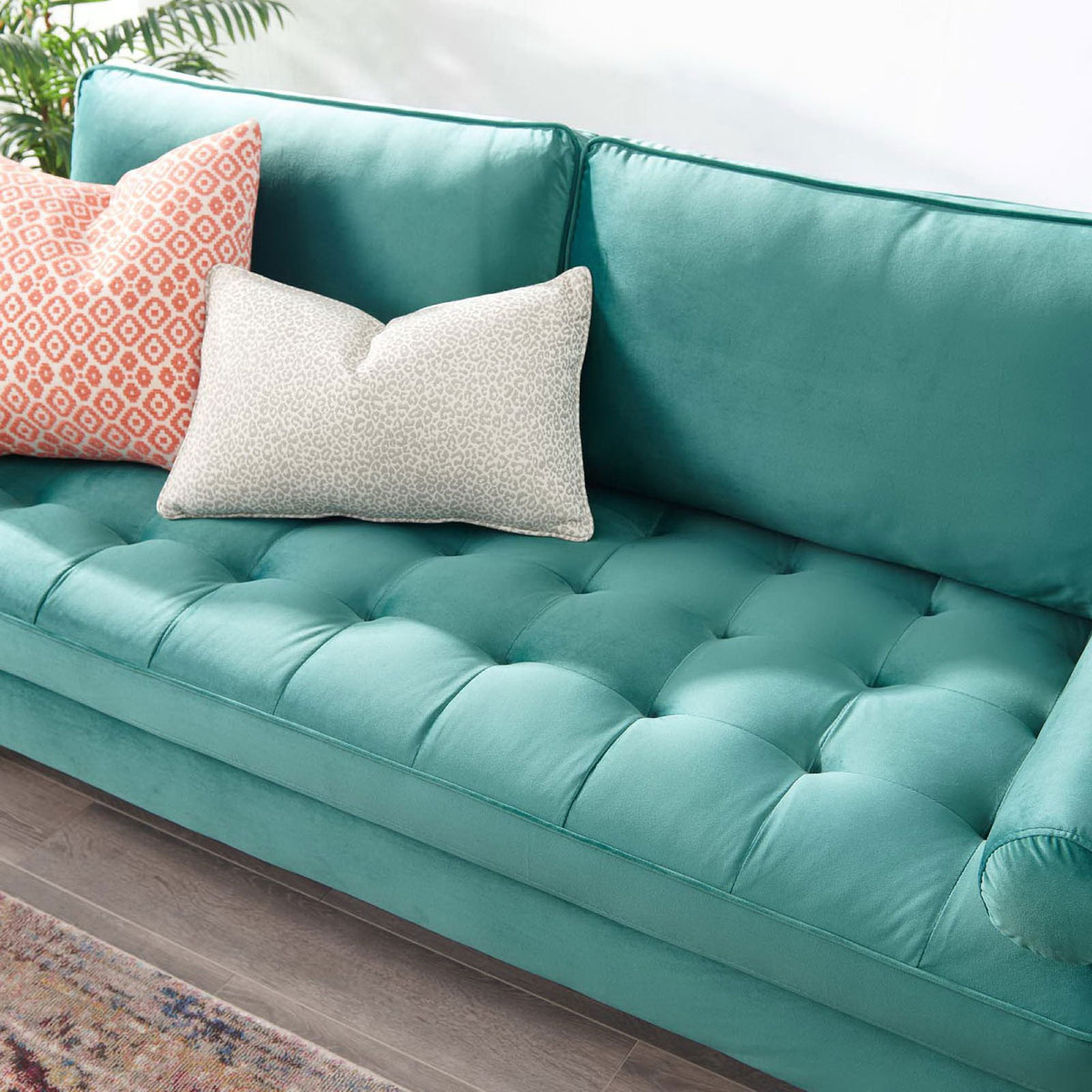 Valour teal sofa seat highlighting biscuit tufting, bolster pillow, and layered decorative cushions || EEI-3764-TEA || detail_room