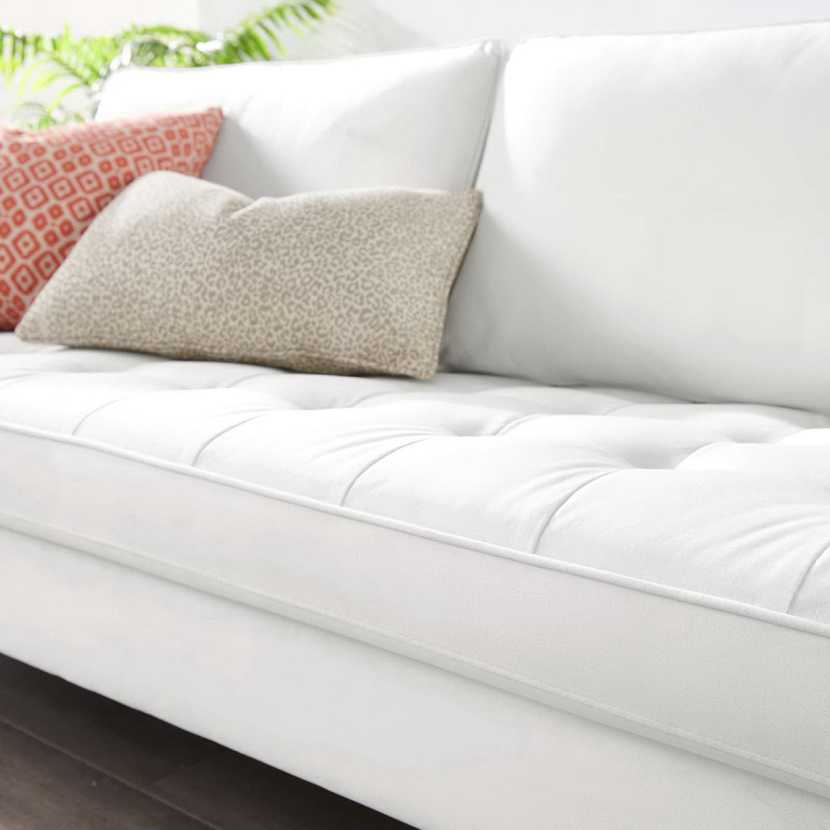 Tufted seat and plush back cushions pair with patterned pillows for casual lounging || EEI-3764-WHI || detail_room