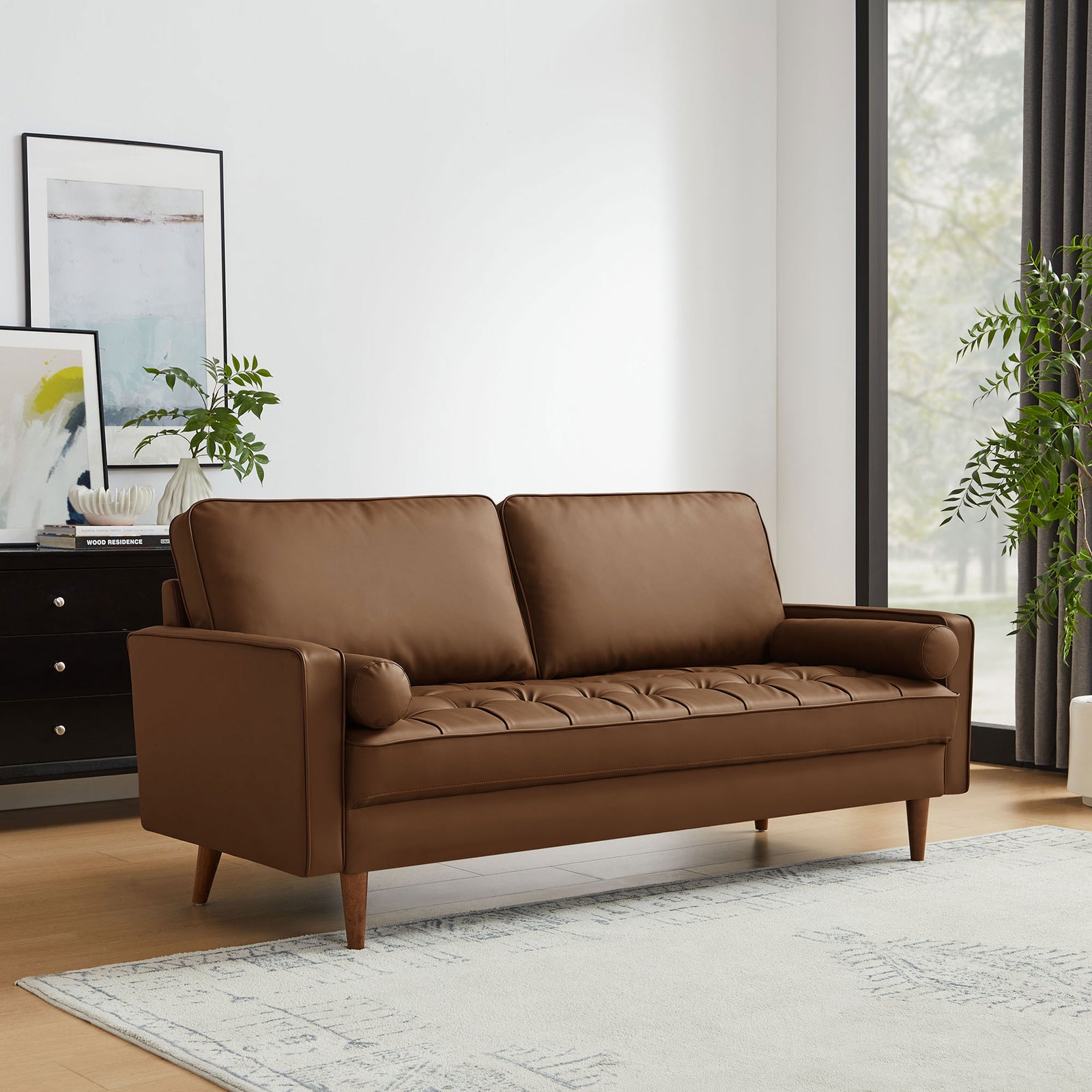 Brown vegan leather Valour sofa styled in a bright living room with rug, artwork, and large windows || EEI-3765-BRN || front_angle_room