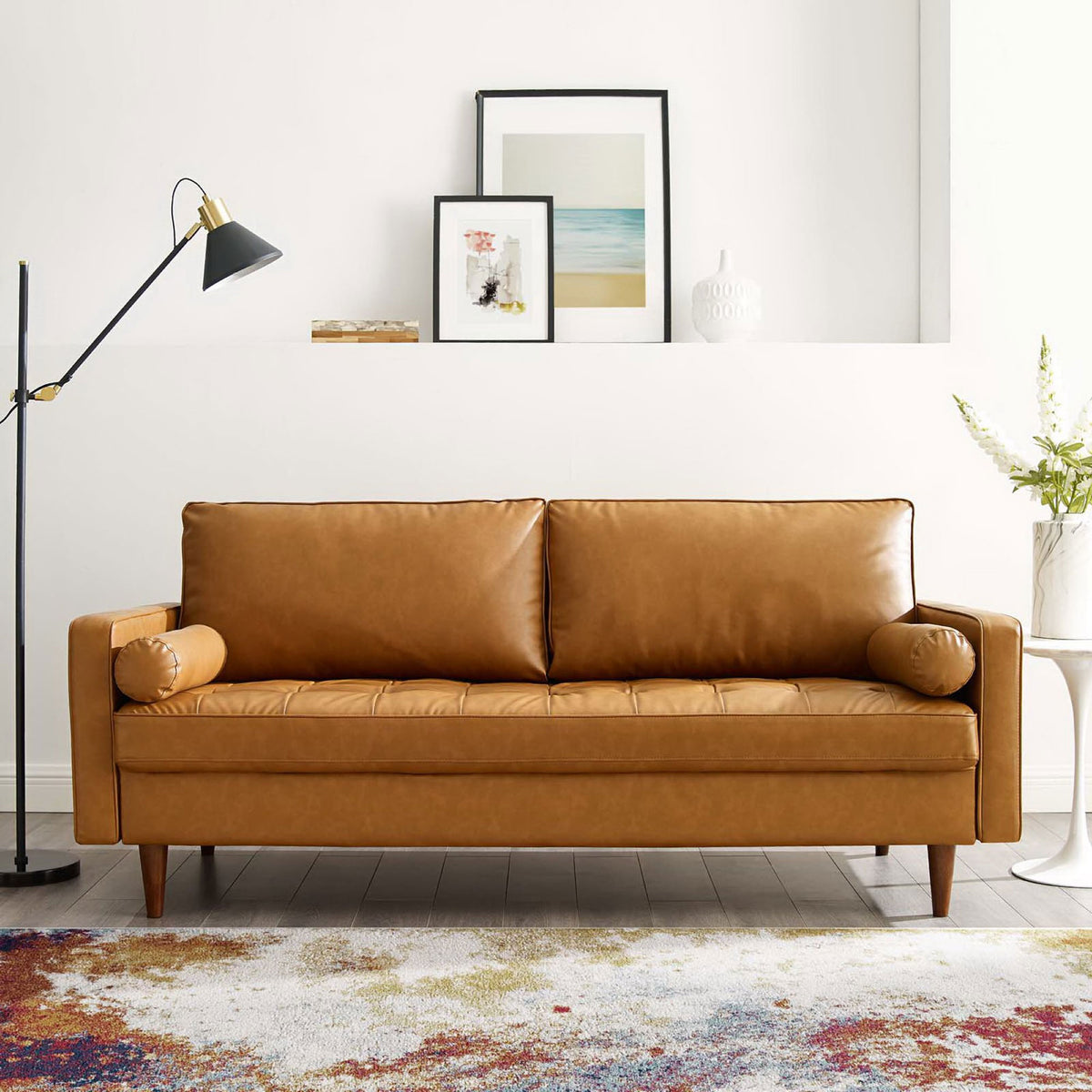 Tan vegan leather sofa styled in a modern living room with colorful rug, floor lamp, and wall art || EEI-3765-TAN || front_room