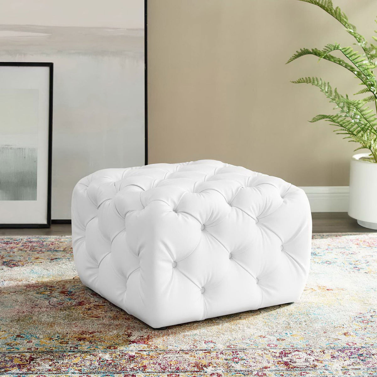 White square tufted ottoman adding plush comfort beside framed art and greenery in a modern room || EEI-3775-WHI || front_angle_room