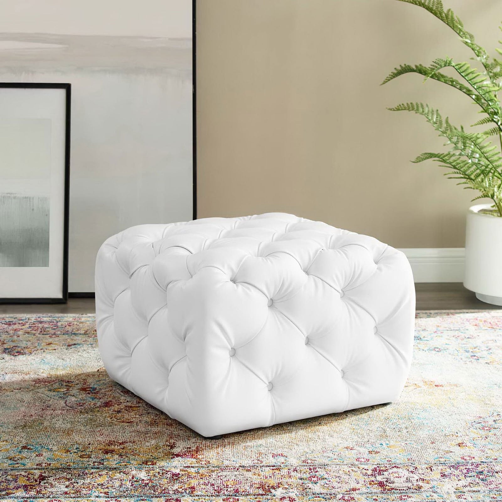 White square tufted ottoman adding plush comfort beside framed art and greenery in a modern room || EEI-3775-WHI || front_angle_room