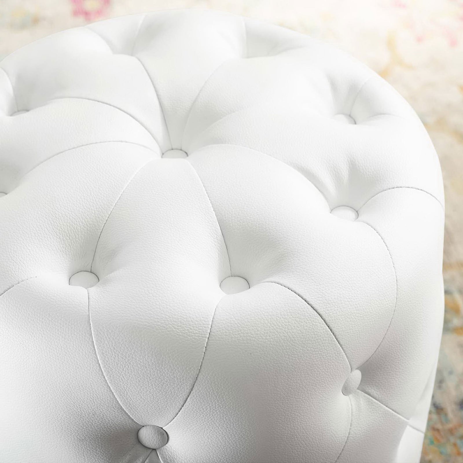 Tufted white faux leather ottoman top styled in a bright living room with a colorful rug. || EEI-3777-WHI || detail_room