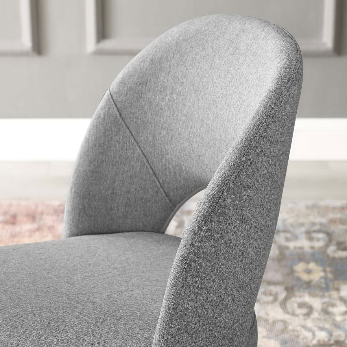 Curved gray backrest with cutout design styled with paneled wall and patterned rug for a chic dining room. || EEI-3801-BLK-LGR || detail_room