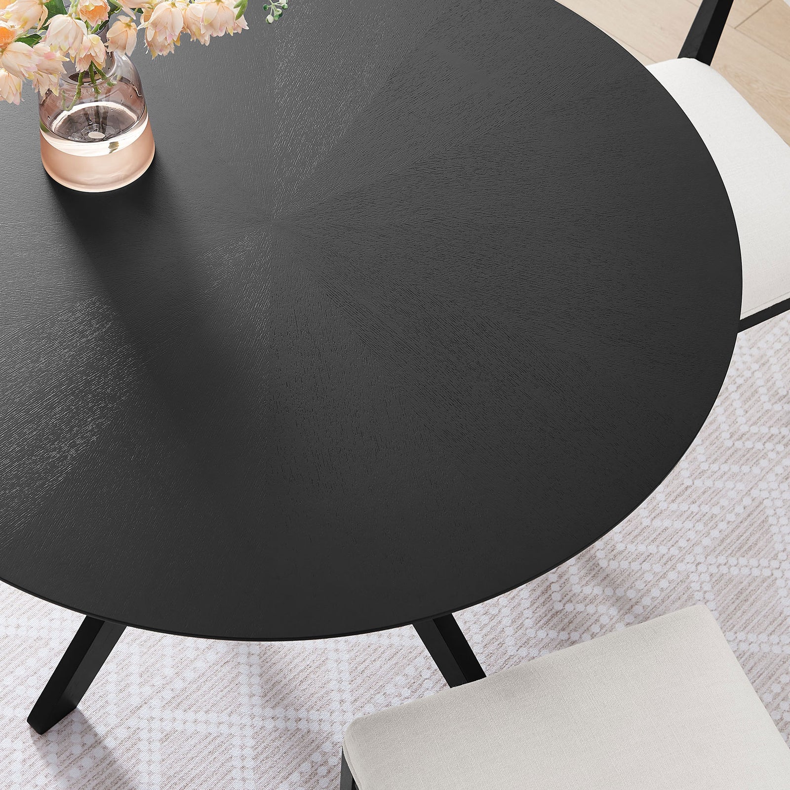 Styled tabletop scene highlighting the black round surface paired with soft neutral dining chairs || EEI-3847-BLK || detail_room