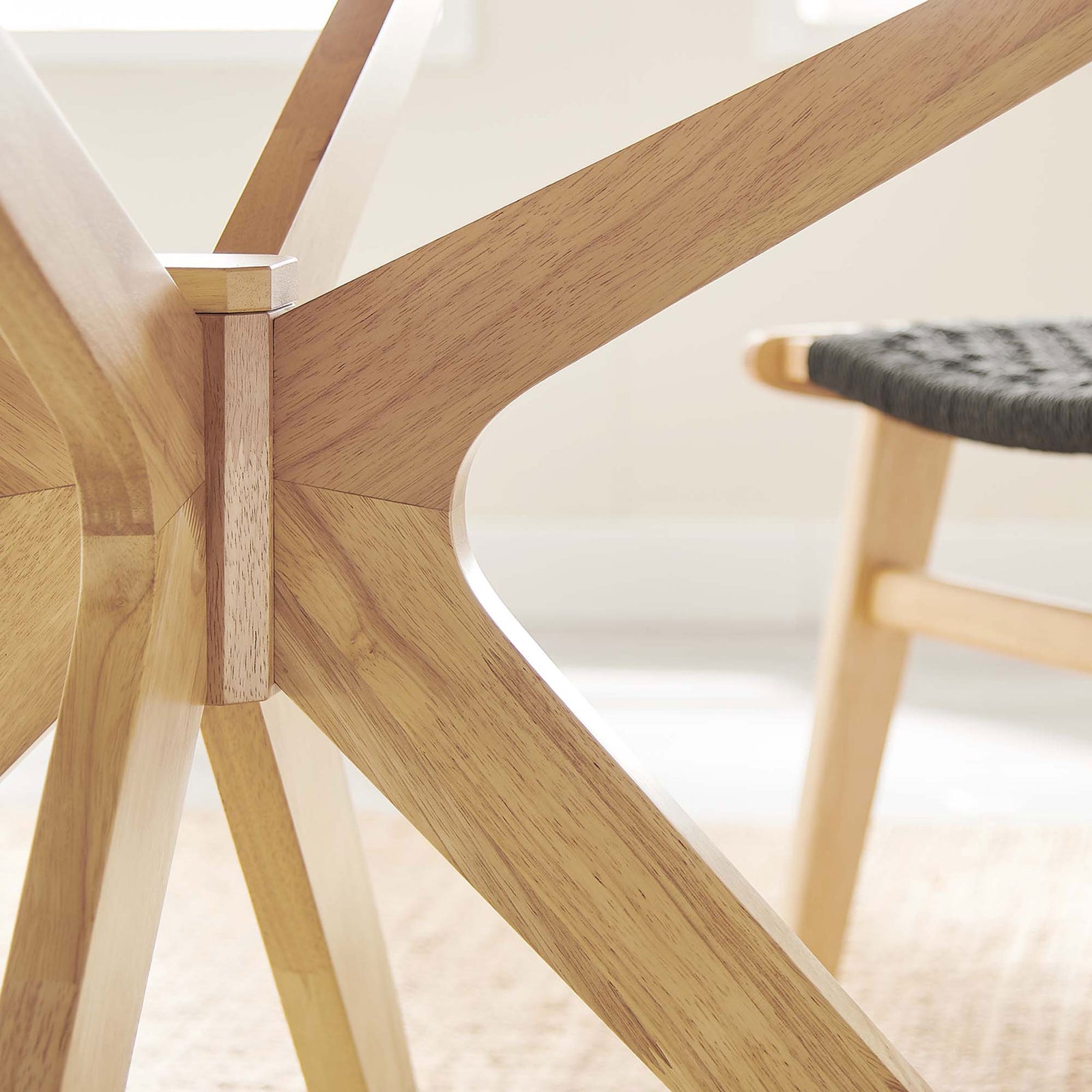 Crafted oak dining table base with smooth joinery and warm wood grain detail in a bright dining space || EEI-3847-OAK || detail_room