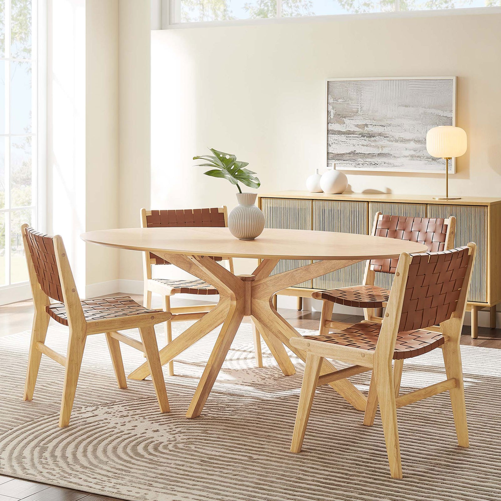 71-inch oak oval dining table styled with four woven chairs in a sunlit dining room with soft neutral decor. || EEI-3849-OAK || front_angle_room