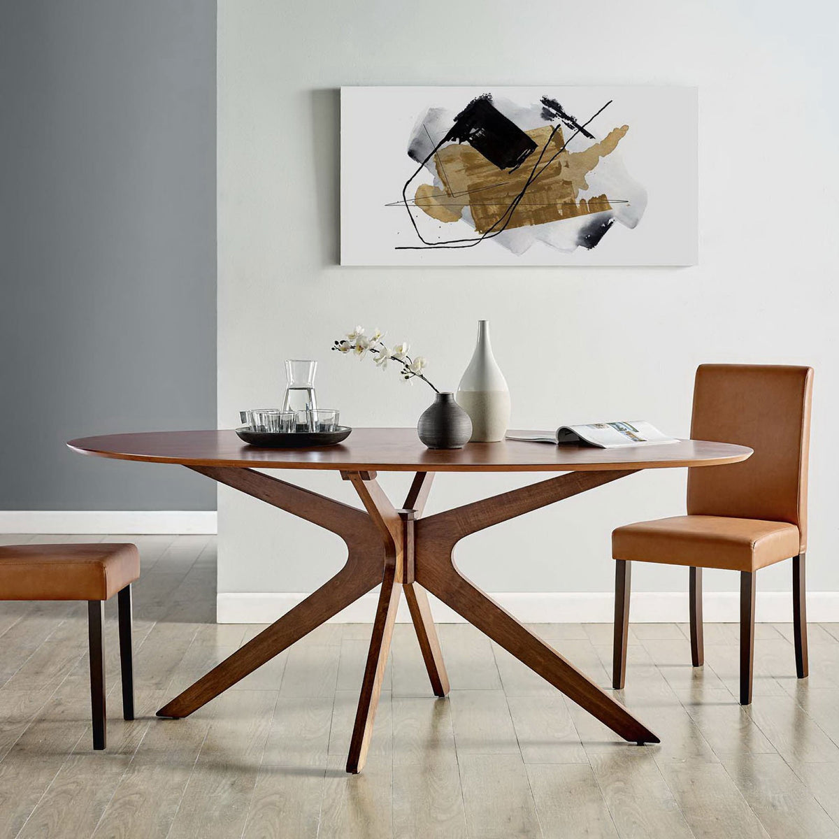 Oval walnut dining table centers a modern dining room with artwork, side chairs, and neutral flooring || EEI-3849-WAL || front_room