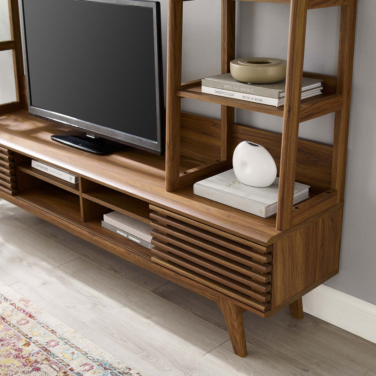 Right-side shelving and media compartments with TV and decor accents on the walnut Render entertainment center || EEI-3863-WAL || detail_room