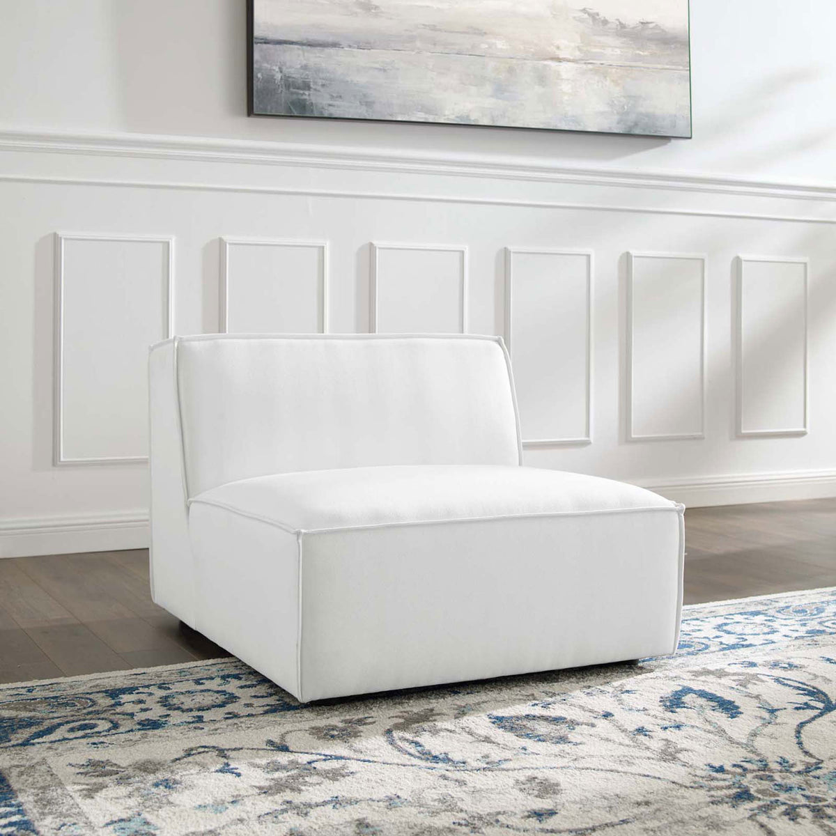 Minimalist white armless chair anchors the living room with plush comfort and clean-lined modern design || EEI-3872-WHI || front_angle_room