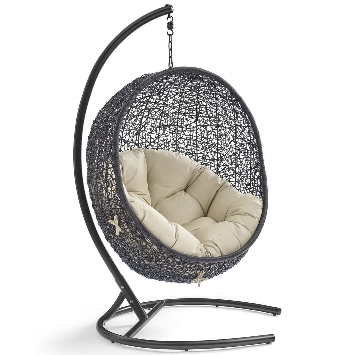 Open-weave rattan pod chair with plush beige Sunbrella cushion on curved espresso stand || EEI-3943-BLK-BEI || front_angle_studio