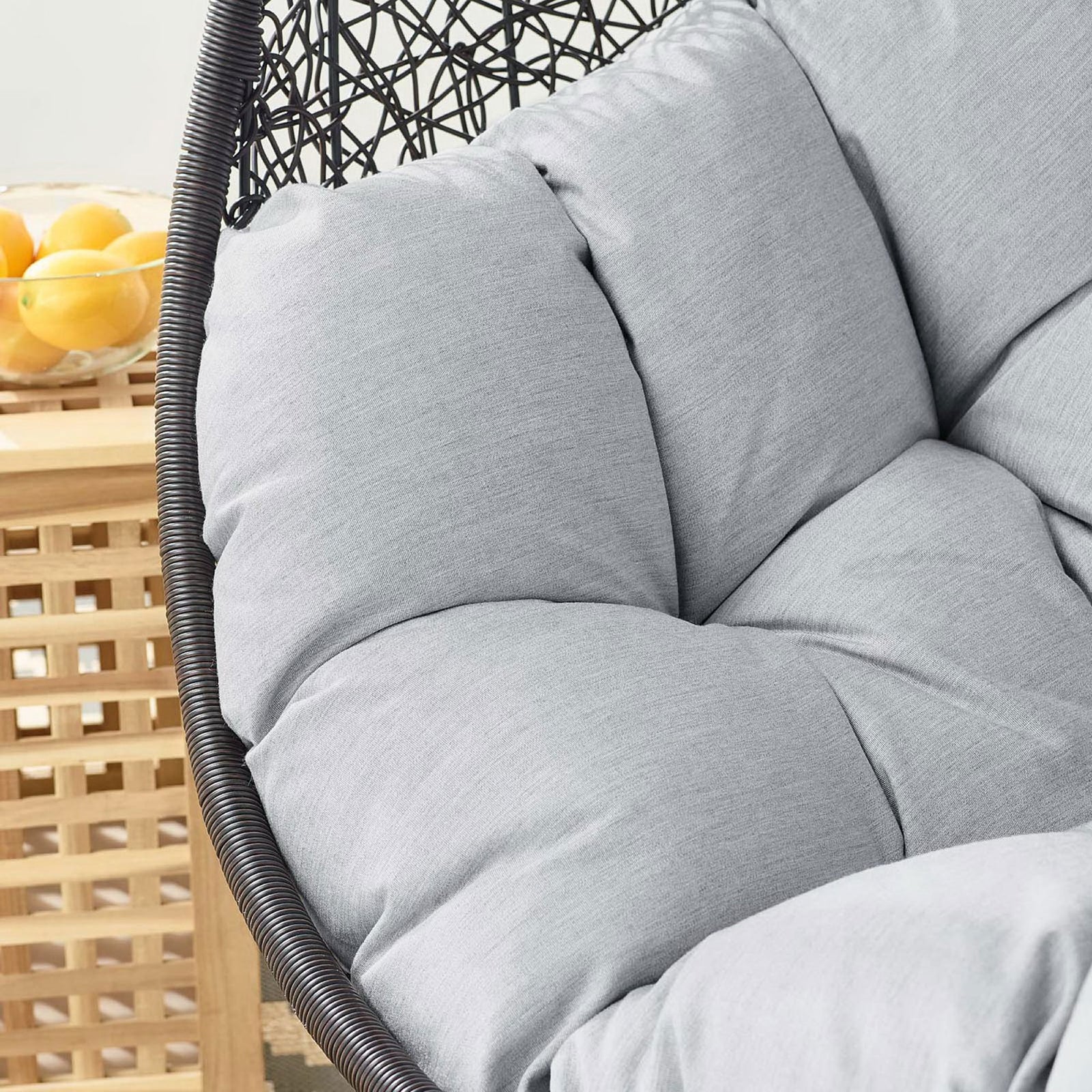 Detail of gray Sunbrella cushion on outdoor egg chair layered with coastal side table and decor || EEI-3943-BLK-GRY || swatch_room