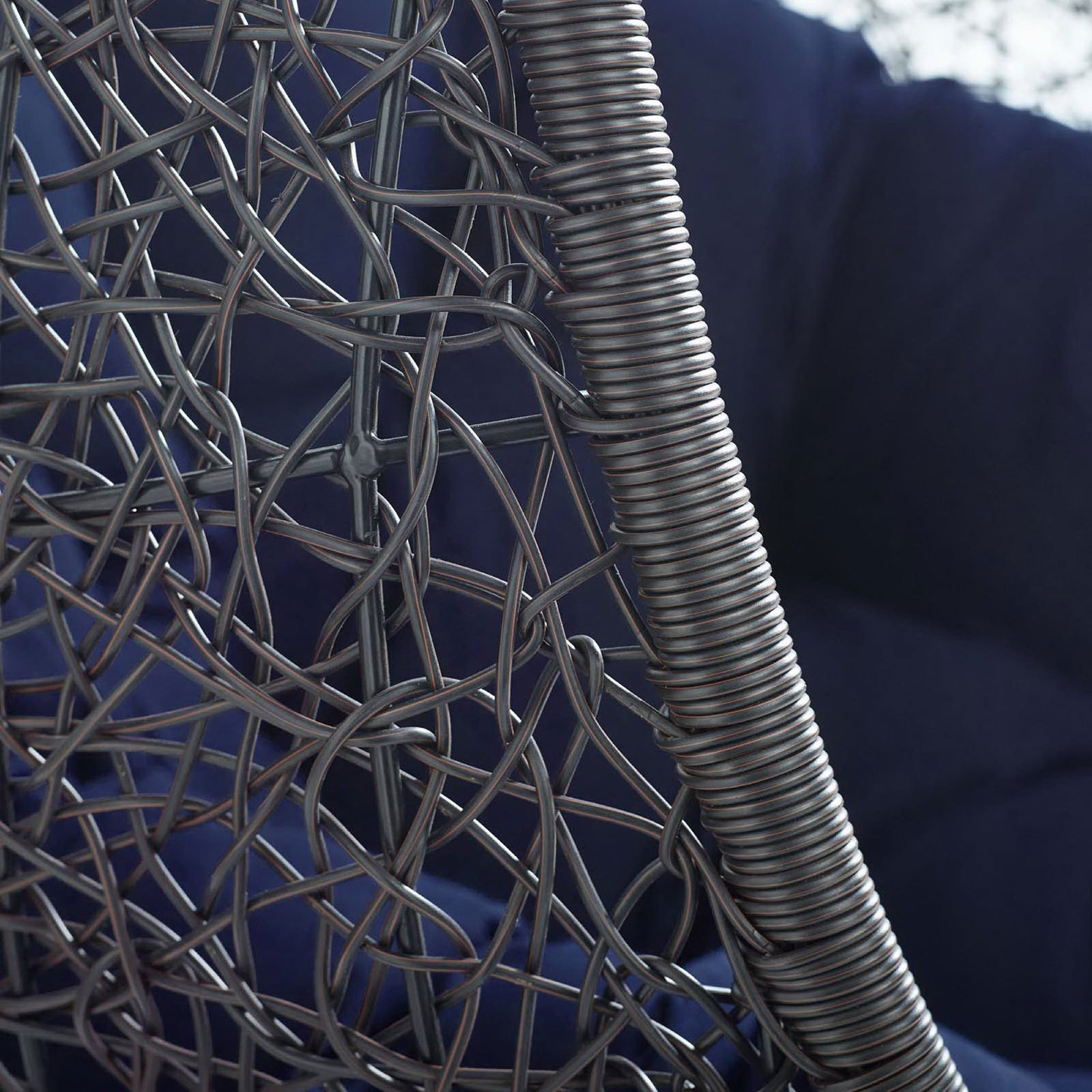 Close-up of dark espresso rattan frame texture framing plush navy outdoor cushion || EEI-3943-BLK-NAV || swatch_studio