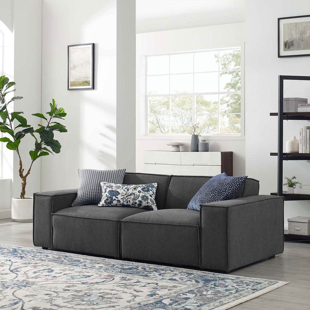 Charcoal gray sectional sofa styled in a bright modern living room with patterned rug and accent pillows || EEI-4111-CHA || front_angle_room