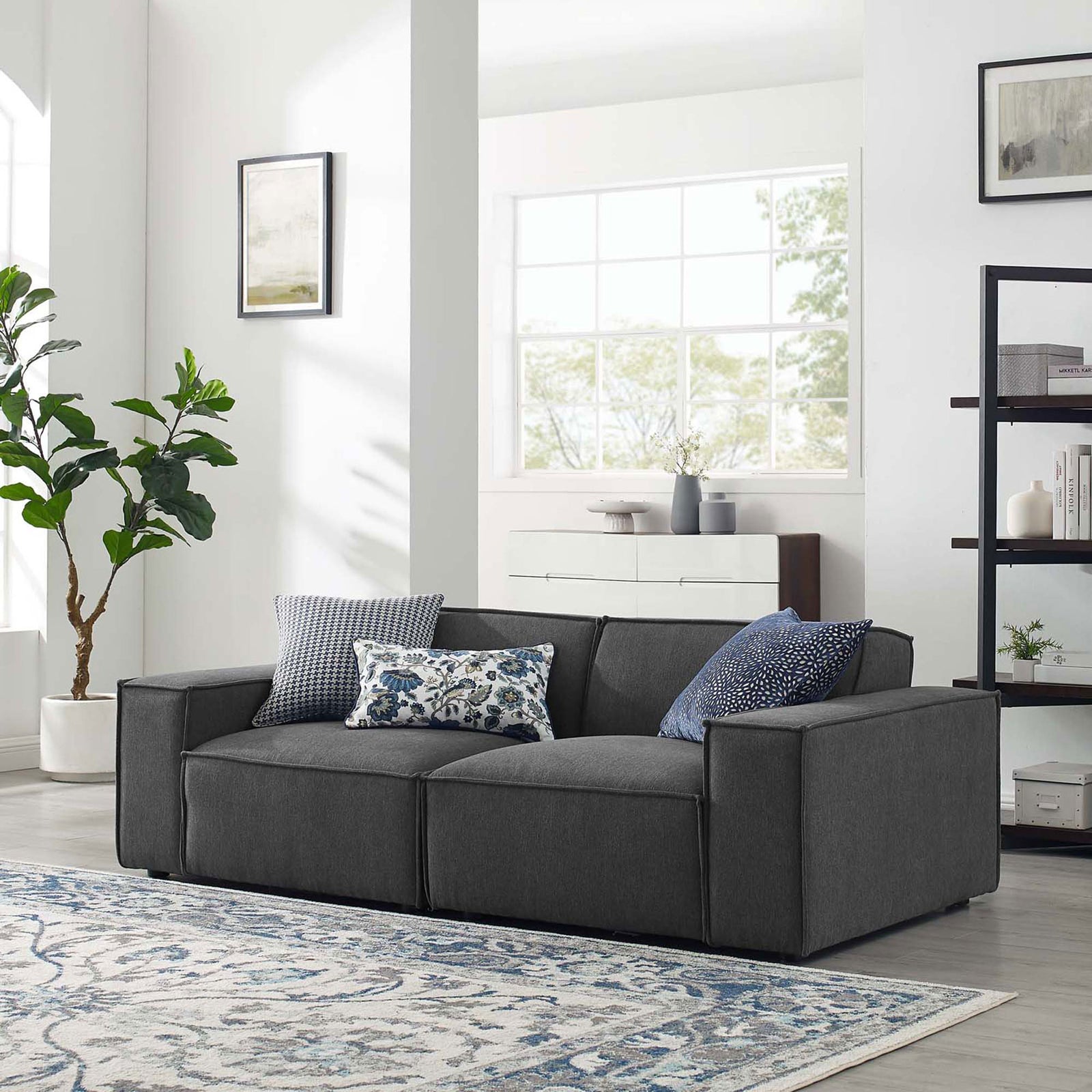Charcoal gray sectional sofa styled in a bright modern living room with patterned rug and accent pillows || EEI-4111-CHA || front_angle_room