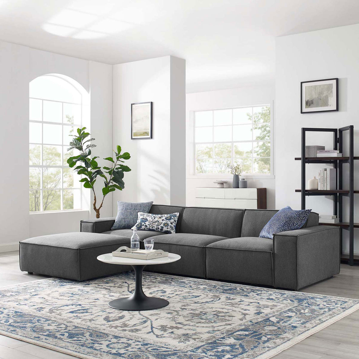 Charcoal 4-piece sectional sofa with chaise styled in a bright living room with rug, pillows, and decor || EEI-4113-CHA || front_angle_room