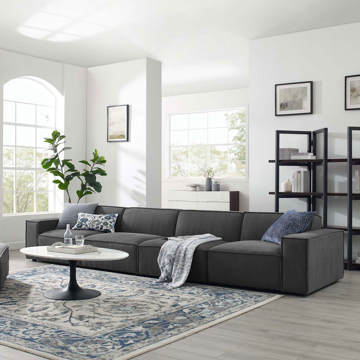 Charcoal 4-piece sectional sofa styled in a bright modern living room with rug, pillows, and decor || EEI-4114-CHA || front_angle_room
