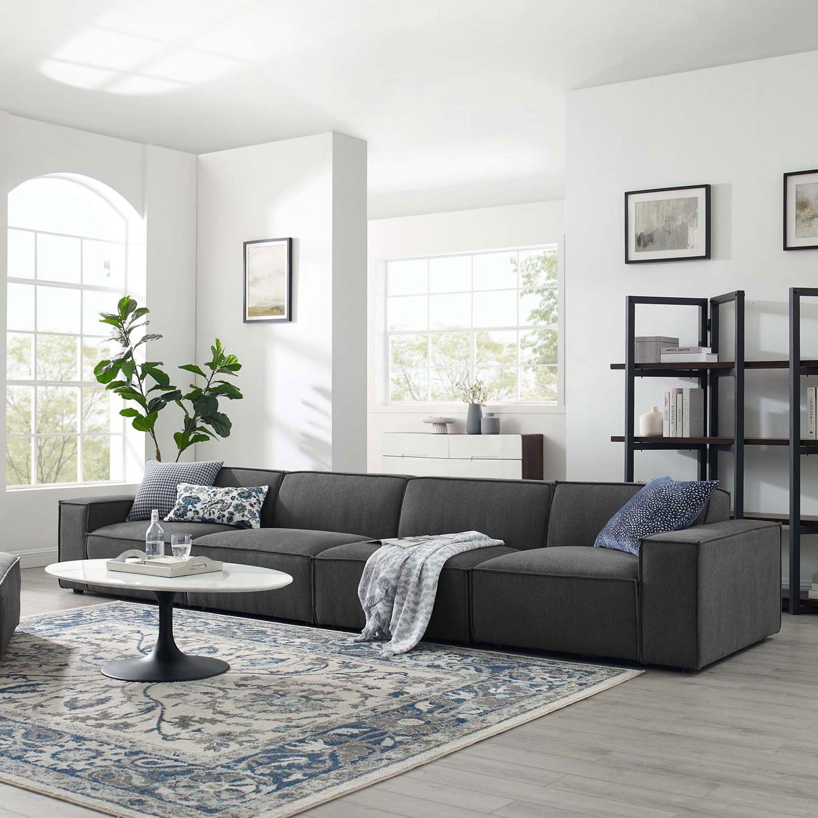 Charcoal 4-piece sectional sofa styled in a bright modern living room with rug, pillows, and decor || EEI-4114-CHA || front_angle_room