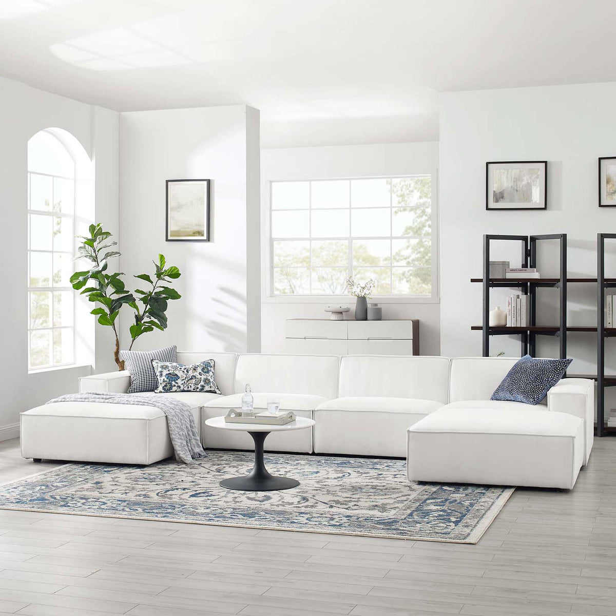 White Restore modular sectional styled in a bright living room with rug, pillows, and side table || EEI-4116-WHI || front_angle_room