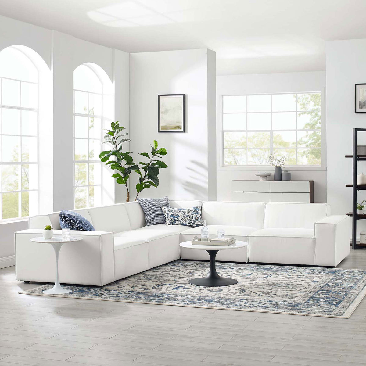 White 5-piece sectional sofa styled in a bright living room with rug, tables, and pillows || EEI-4117-WHI || front_angle_room