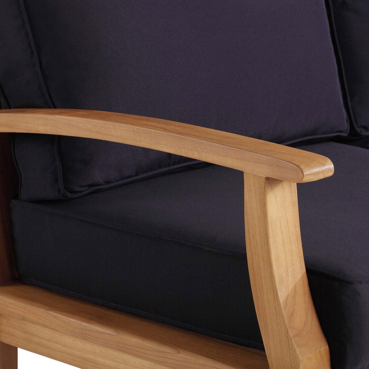 Smooth teak armrest and tailored navy cushions showcase the sofa's premium outdoor design || EEI-4176-NAT-NAV || detail_studio