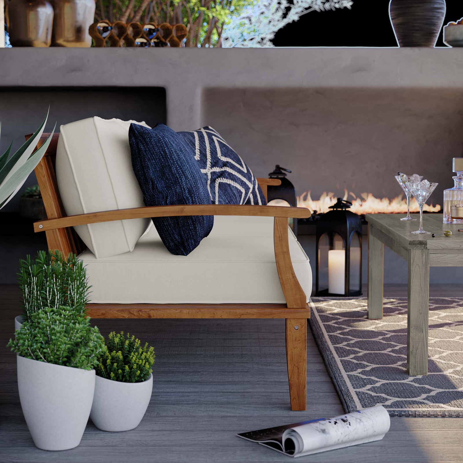 Side of teak outdoor sofa with navy accent pillows beside planters and a coordinating coffee table || EEI-4176-NAT-WHI || detail_room