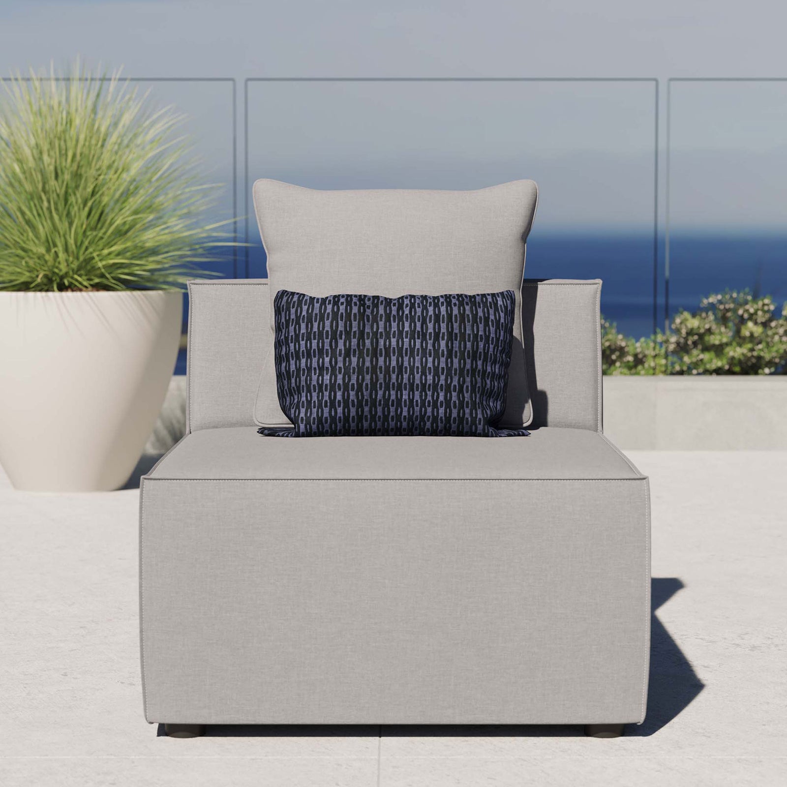 Gray outdoor armless sectional chair styled on a sunny patio with ocean view, featuring plush cushion comfort || EEI-4209-GRY || front_room