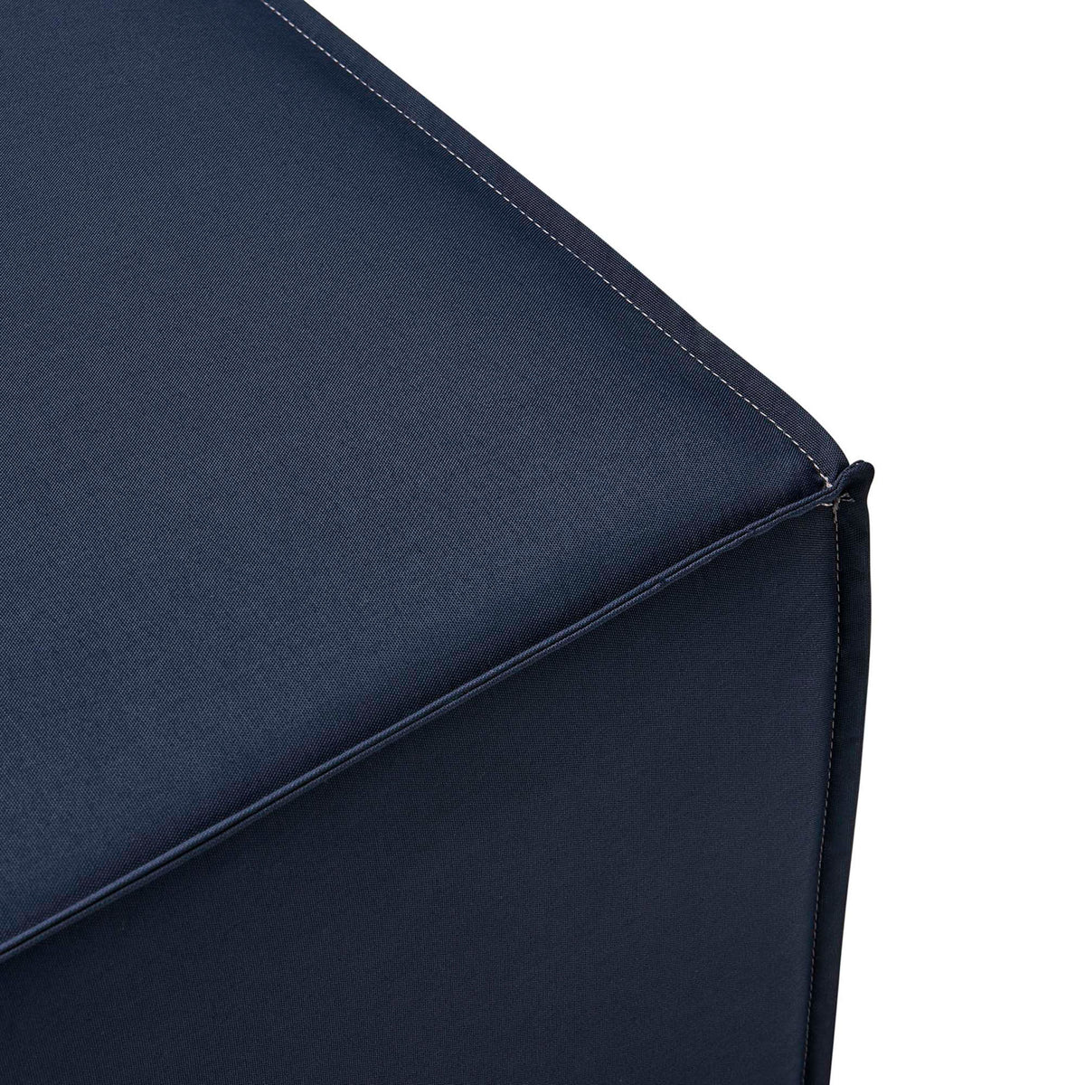 Navy ottoman corner detail with refined stitching and neatly tailored piping along the edge || EEI-4211-NAV || detail_studio