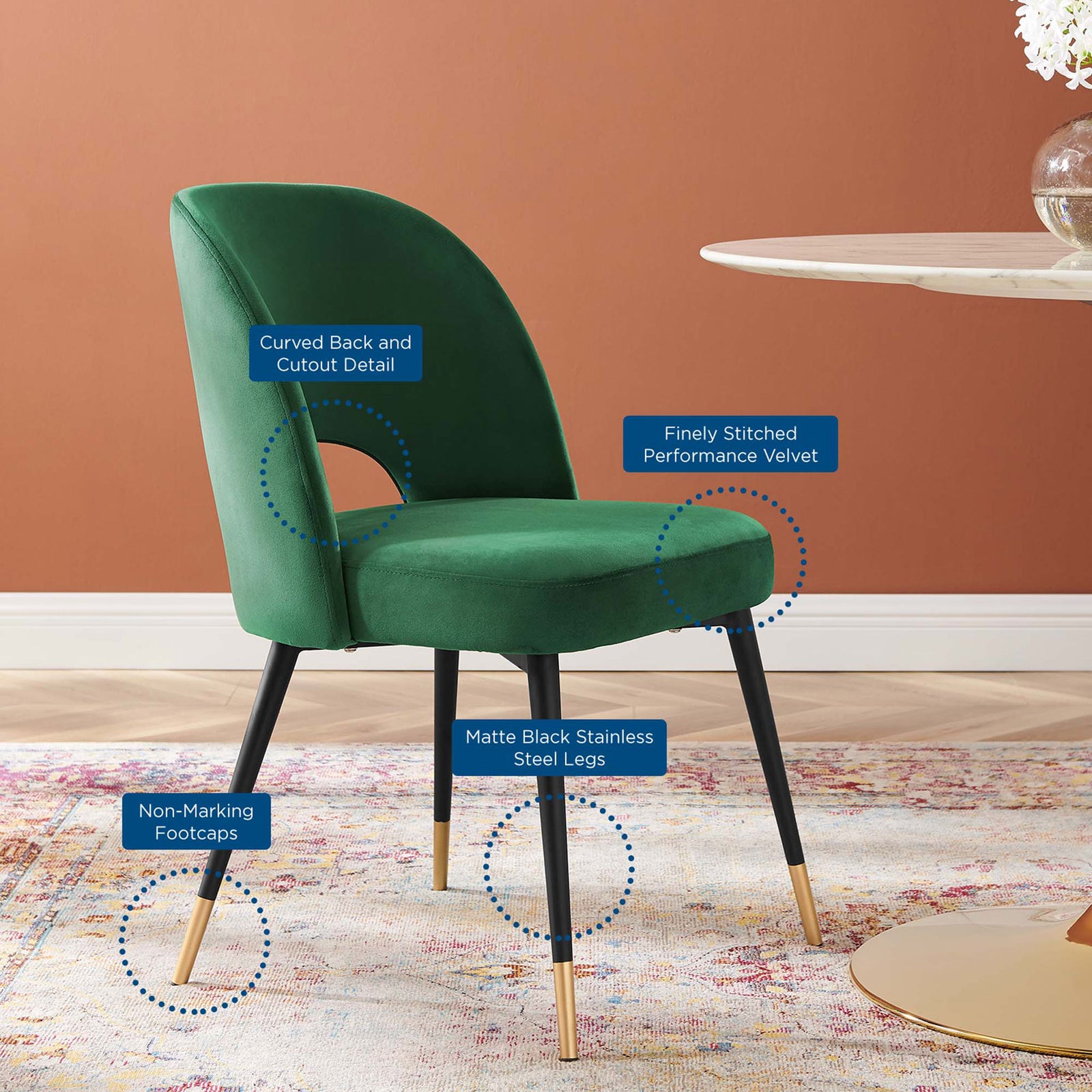 Emerald velvet dining chair in a room setting highlighting curved back, cutout, and chic metal legs. || EEI-4212-EME || callout_room
