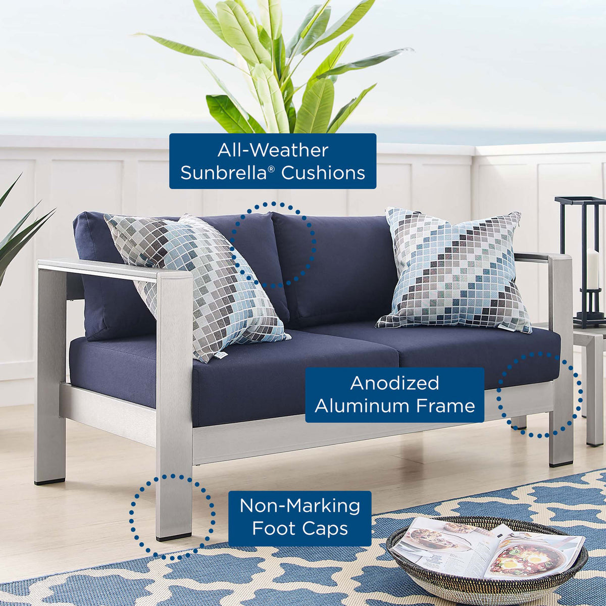 Sunbrella cushions, anodized aluminum frame, and foot caps highlighted with callouts on navy loveseat || EEI-4226-SLV-NAV || callout_room