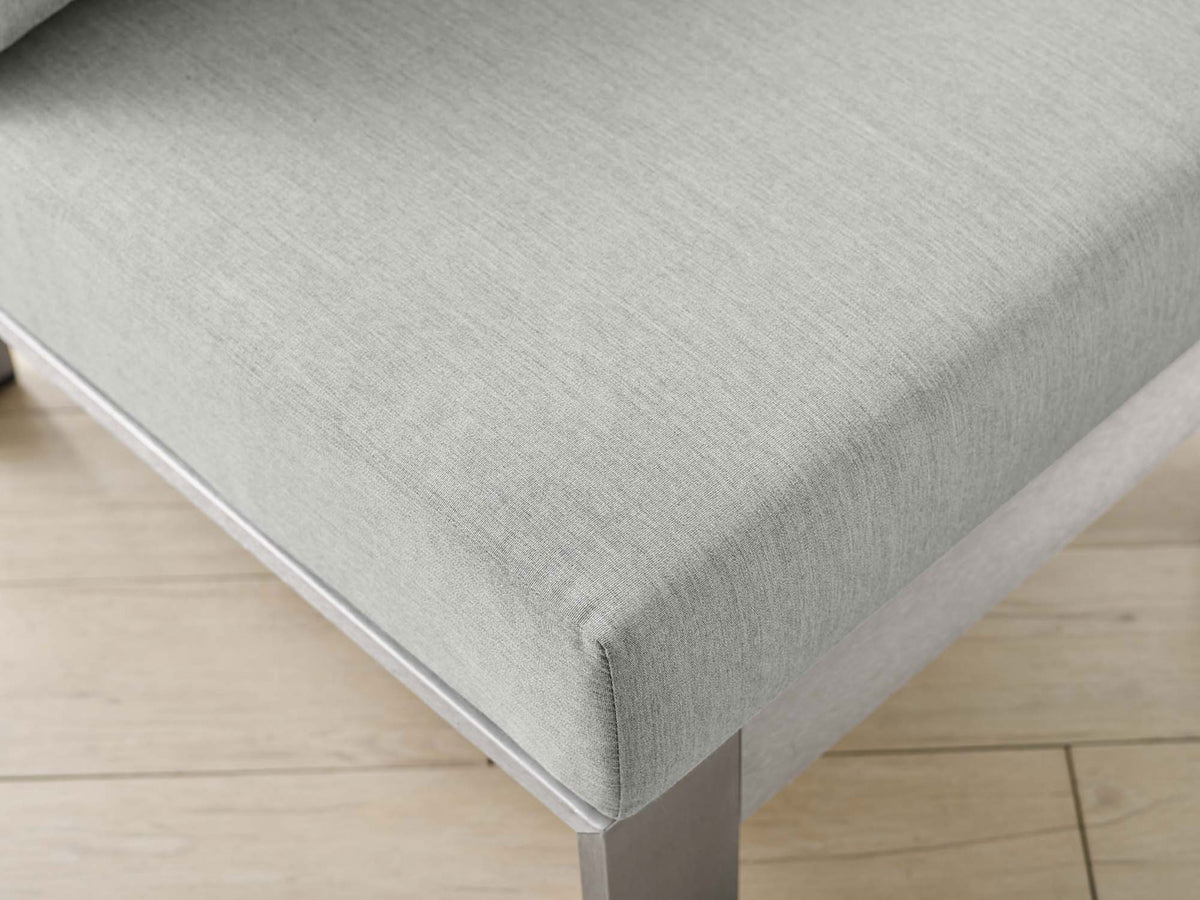 Soft gray Sunbrella(r) upholstery and smooth seat surface lend airy elegance to outdoor spaces || EEI-4227-SLV-GRY || detail_room