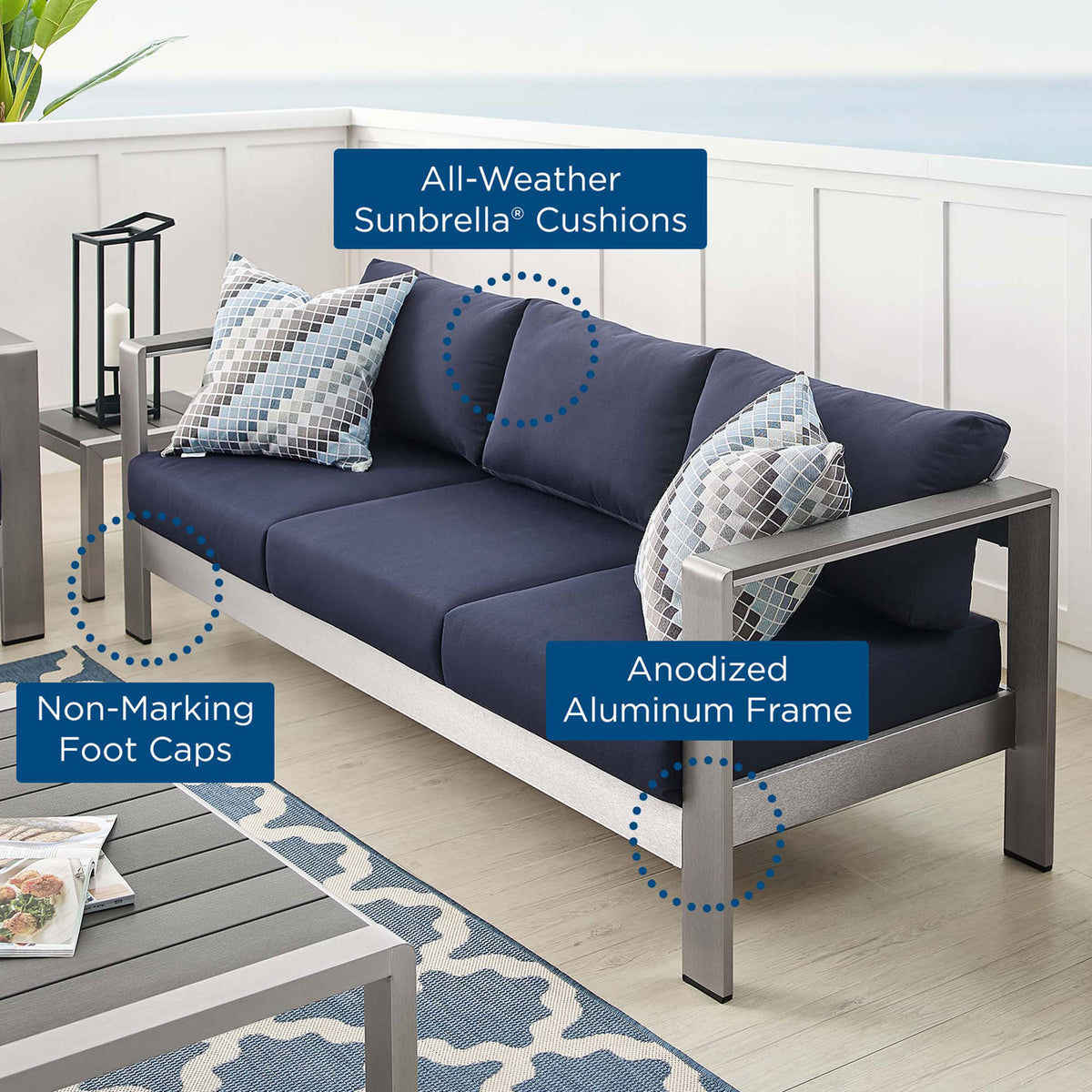 Outdoor sofa highlights all-weather Sunbrella cushions, anodized aluminum frame, and protective foot caps || EEI-4228-SLV-NAV || callout_room