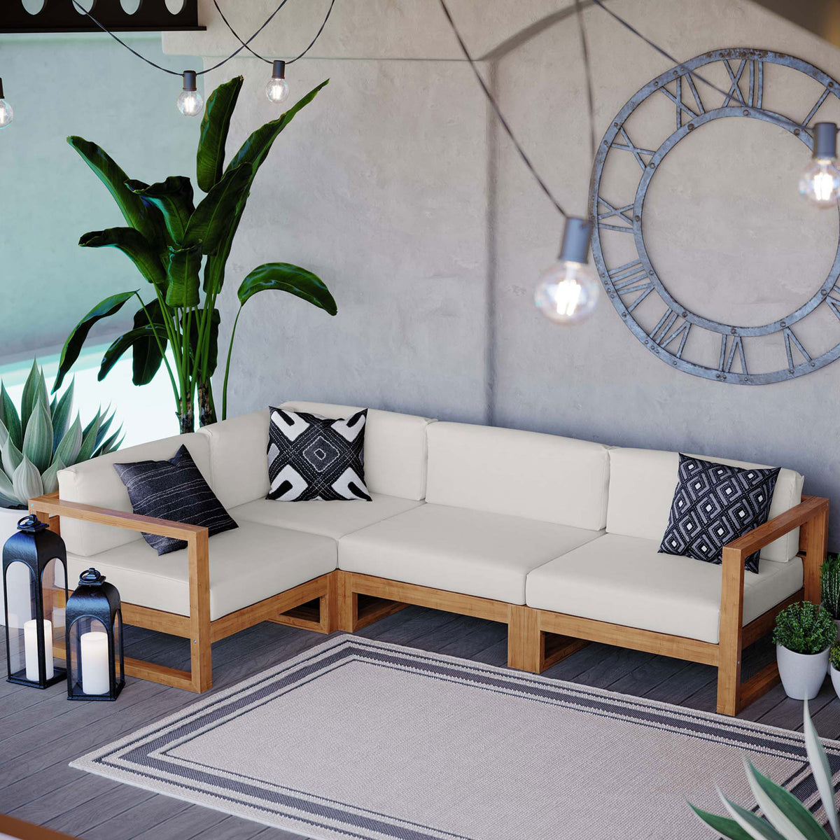 Spacious outdoor lounge with teak sectional, accent pillows, greenery, and lanterns on a deck || EEI-4253-NAT-WHI-SET || front_angle_room