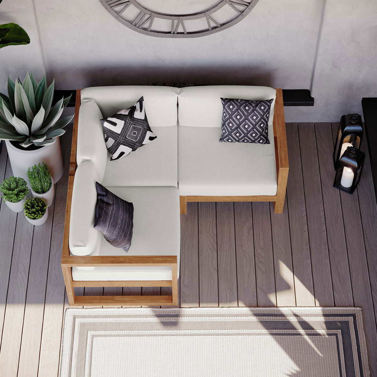 Modular teak sectional arranged on a modern deck with neutral rug and patterned accent pillows || EEI-4255-NAT-WHI-SET || top_room