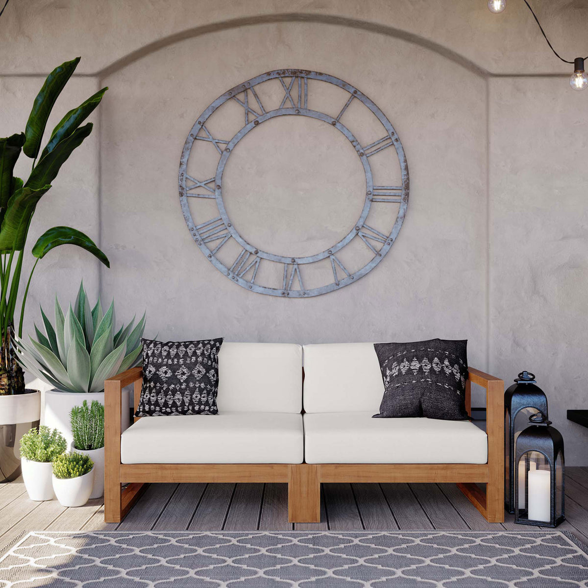 Teak outdoor loveseat with white cushions styled with patterned pillows on a covered patio || EEI-4256-NAT-WHI-SET || front_room