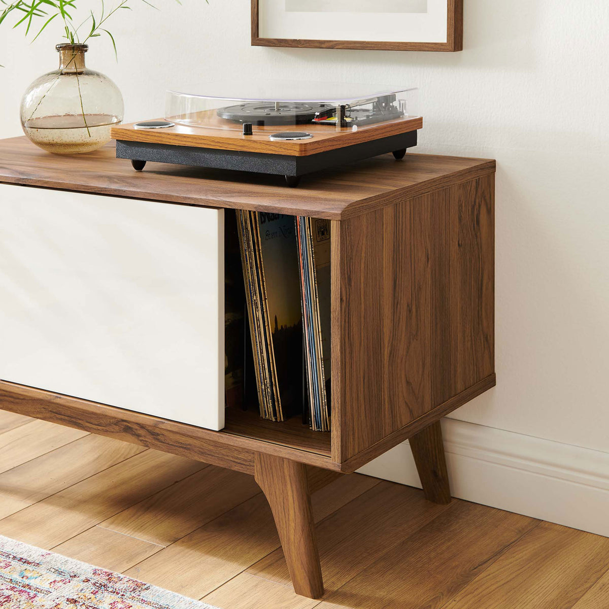 Turntable and records rest on the walnut and white stand, bringing warmth to the room || EEI-4261-WAL-WHI || detail_room