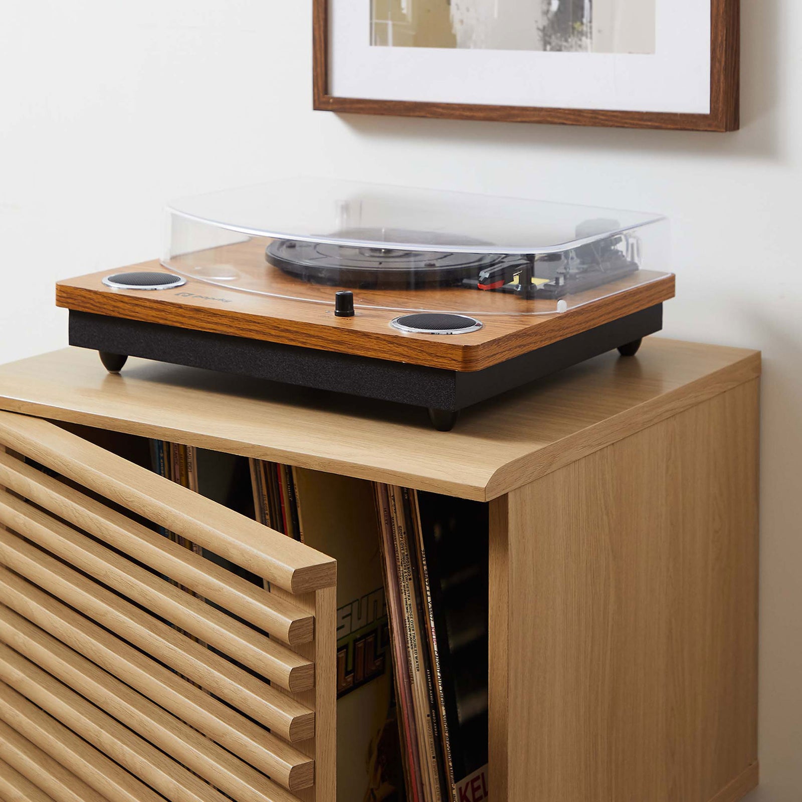 Oak record stand with turntable on top and vinyl albums stored inside in a modern room || EEI-4262-OAK || detail_open_room